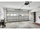 Spacious two car garage featuring a modern garage door and durable flooring at 670 Fayette Ct, The Villages, FL 32162