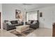 Comfortable living room with neutral decor, ceiling fan, and natural light at 670 Fayette Ct, The Villages, FL 32162