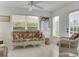 Bright sitting room featuring wicker furniture and lots of natural light at 670 Fayette Ct, The Villages, FL 32162