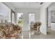 Bright sitting area featuring wicker furniture and access to the backyard at 670 Fayette Ct, The Villages, FL 32162