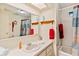 Functional bathroom with a single sink vanity, large mirror, and a bathtub with a shower at 717 W Coach N Four Dr, Leesburg, FL 34748