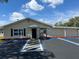 Office building exterior featuring accessible parking, a well-maintained landscape, and a welcoming entrance at 717 W Coach N Four Dr, Leesburg, FL 34748