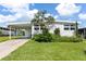 Charming single-story home with a well-maintained lawn and covered parking at 717 W Coach N Four Dr, Leesburg, FL 34748