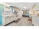 Bright kitchen featuring white cabinets and appliances with an adjoining dinette area at 717 W Coach N Four Dr, Leesburg, FL 34748