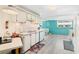 Modern kitchen boasts updated appliances, white cabinets, and a seamless layout that connects to the living area at 717 W Coach N Four Dr, Leesburg, FL 34748