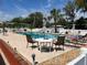 Relaxing community pool with lounge chairs, tables, and umbrellas for residents' enjoyment at 717 W Coach N Four Dr, Leesburg, FL 34748