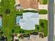 Overhead view of the house showing pool with screened enclosure, lush lawn, landscaping, and neighboring houses at 804 Santa Rita Way, Lady Lake, FL 32159