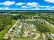 Beautiful aerial view of a lovely neighborhood with a pond and well-maintained landscaping, highlighting the property's location at 804 Santa Rita Way, Lady Lake, FL 32159