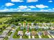 Aerial view of the home showcasing its location near a community green space, trees, and neighborhood at 804 Santa Rita Way, Lady Lake, FL 32159