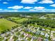 Aerial view of the home showcasing its location near a community green space, trees, and neighborhood at 804 Santa Rita Way, Lady Lake, FL 32159