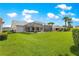 Expansive backyard featuring lush green grass, a screened lanai, and picturesque landscaping at 804 Santa Rita Way, Lady Lake, FL 32159