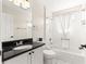 Clean, well-lit bathroom featuring a shower and tub combo with a granite vanity at 804 Santa Rita Way, Lady Lake, FL 32159