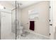 Bright bathroom features a glass enclosed shower with white tile and a window for natural light at 804 Santa Rita Way, Lady Lake, FL 32159