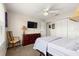 Comfortable bedroom with a ceiling fan, closet, and view to outdoor nature at 804 Santa Rita Way, Lady Lake, FL 32159
