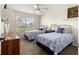Charming bedroom with two twin beds, ceiling fan, and bright natural light at 804 Santa Rita Way, Lady Lake, FL 32159