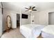 Bedroom with a four-poster bed, neutral carpet, sliding glass door to the backyard and large television at 804 Santa Rita Way, Lady Lake, FL 32159