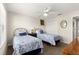 Comfortable bedroom featuring twin beds, ceiling fan, and closet for storage at 804 Santa Rita Way, Lady Lake, FL 32159