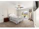 Bedroom features a four-poster bed, neutral carpet, and sliding glass doors to the outdoor space at 804 Santa Rita Way, Lady Lake, FL 32159