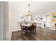 Charming dining area with wood floors, decorative chandelier, and easy access to kitchen and rooms at 804 Santa Rita Way, Lady Lake, FL 32159