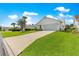 Single-story home with a two-car garage, manicured lawn, and well-maintained landscaping on a sunny day at 804 Santa Rita Way, Lady Lake, FL 32159