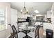 Bright eat-in kitchen with white cabinets, black countertops, and modern lighting at 804 Santa Rita Way, Lady Lake, FL 32159