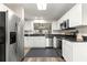 Modern kitchen boasts stainless steel appliances, white cabinets, and granite countertops at 804 Santa Rita Way, Lady Lake, FL 32159