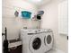 Laundry room features a front loading washer and dryer with shelving above for extra storage at 804 Santa Rita Way, Lady Lake, FL 32159
