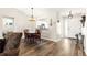 View of the dining area, laundry, and front entry hall from the living room with beautiful hard wood floors at 804 Santa Rita Way, Lady Lake, FL 32159