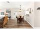 Open-concept living area featuring wood floors connecting the living room to the dining area and kitchen at 804 Santa Rita Way, Lady Lake, FL 32159