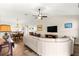 Bright living room with vaulted ceilings, ceiling fan, hardwood floors, and a comfortable white sectional sofa at 804 Santa Rita Way, Lady Lake, FL 32159