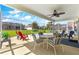 Enclosed patio with a hot tub, furniture, ceiling fan and views of the backyard at 804 Santa Rita Way, Lady Lake, FL 32159