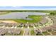 Aerial view of a residential neighborhood surrounding a lake, showcasing community layout and scenic surroundings at 872 Griffon Ave, Lake Alfred, FL 33850