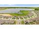 Aerial view of a residential neighborhood surrounding a lake, showcasing community layout and scenic surroundings at 872 Griffon Ave, Lake Alfred, FL 33850