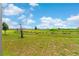 Expansive backyard with lake views, complemented by lush greenery, offering a serene outdoor space at 872 Griffon Ave, Lake Alfred, FL 33850