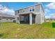 A screened patio provides a tranquil space in the backyard overlooking the grass at 872 Griffon Ave, Lake Alfred, FL 33850