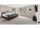 Serene bedroom with plush carpeting, large windows, and a view of the outdoors at 872 Griffon Ave, Lake Alfred, FL 33850
