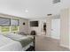 Bright bedroom showcasing natural light, plush carpeting, and a serene view at 872 Griffon Ave, Lake Alfred, FL 33850