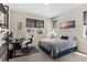 Cozy bedroom with a large window, desk and decor at 872 Griffon Ave, Lake Alfred, FL 33850