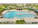 Resort style swimming pool features a large deck with lounge chairs and palm trees at community center at 872 Griffon Ave, Lake Alfred, FL 33850