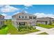 Attractive two-story home featuring a front yard with lush, green landscaping at 872 Griffon Ave, Lake Alfred, FL 33850