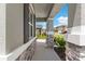 Covered front porch with stone pillars and vibrant landscaping at 872 Griffon Ave, Lake Alfred, FL 33850