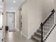 Hallway leading to a stairway, front door, and a view through to an adjacent room at 872 Griffon Ave, Lake Alfred, FL 33850