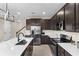Spacious kitchen with stainless steel appliances, dark cabinets, and an island, perfect for cooking at 872 Griffon Ave, Lake Alfred, FL 33850