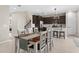 Open floor plan of the dining and kitchen with stainless appliances and lots of natural light at 872 Griffon Ave, Lake Alfred, FL 33850