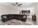 Spacious living room with an open floor plan and cozy leather sofa at 872 Griffon Ave, Lake Alfred, FL 33850