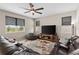 Comfortable living room with a ceiling fan, large television, and plush leather seating at 872 Griffon Ave, Lake Alfred, FL 33850
