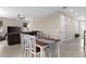 Open-concept living room and dining area with neutral tones and ample natural light at 872 Griffon Ave, Lake Alfred, FL 33850