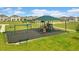 Community playground featuring swings, slides, and a shaded play structure for enjoyment at 872 Griffon Ave, Lake Alfred, FL 33850