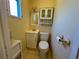 Bathroom featuring a tile floor, single sink vanity, and decorative fixtures at 902 Rose Ln, Lady Lake, FL 32159