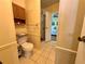 Cozy bathroom with a toilet, a walk-in shower and cabinets with storage space at 902 Rose Ln, Lady Lake, FL 32159